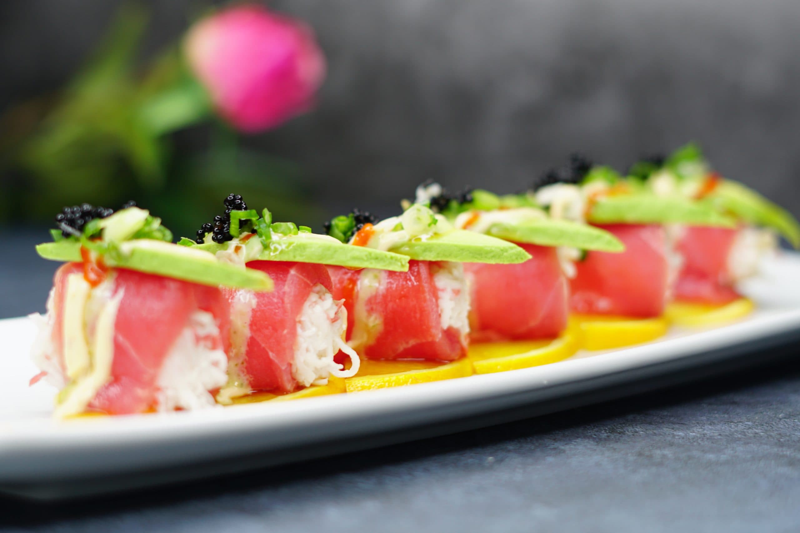 A rice-less roll wrapped in ruby-red tuna, topped with sliced avocado and black tobiko